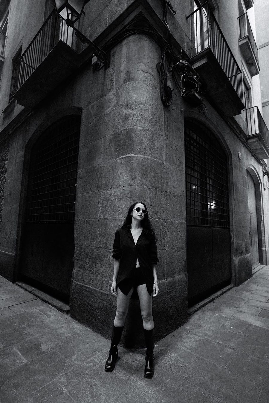 Black and white, in front of a heavy wooden door